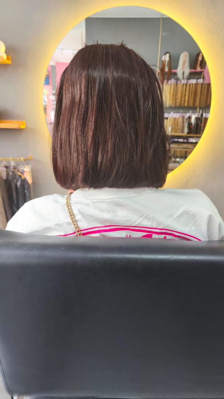 Client before — short mahogany bob at the styling chair