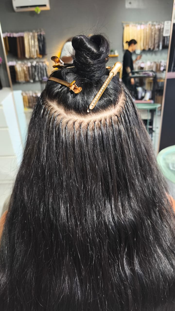 Keratin Bond installation in progress, hair sectioned and clipped