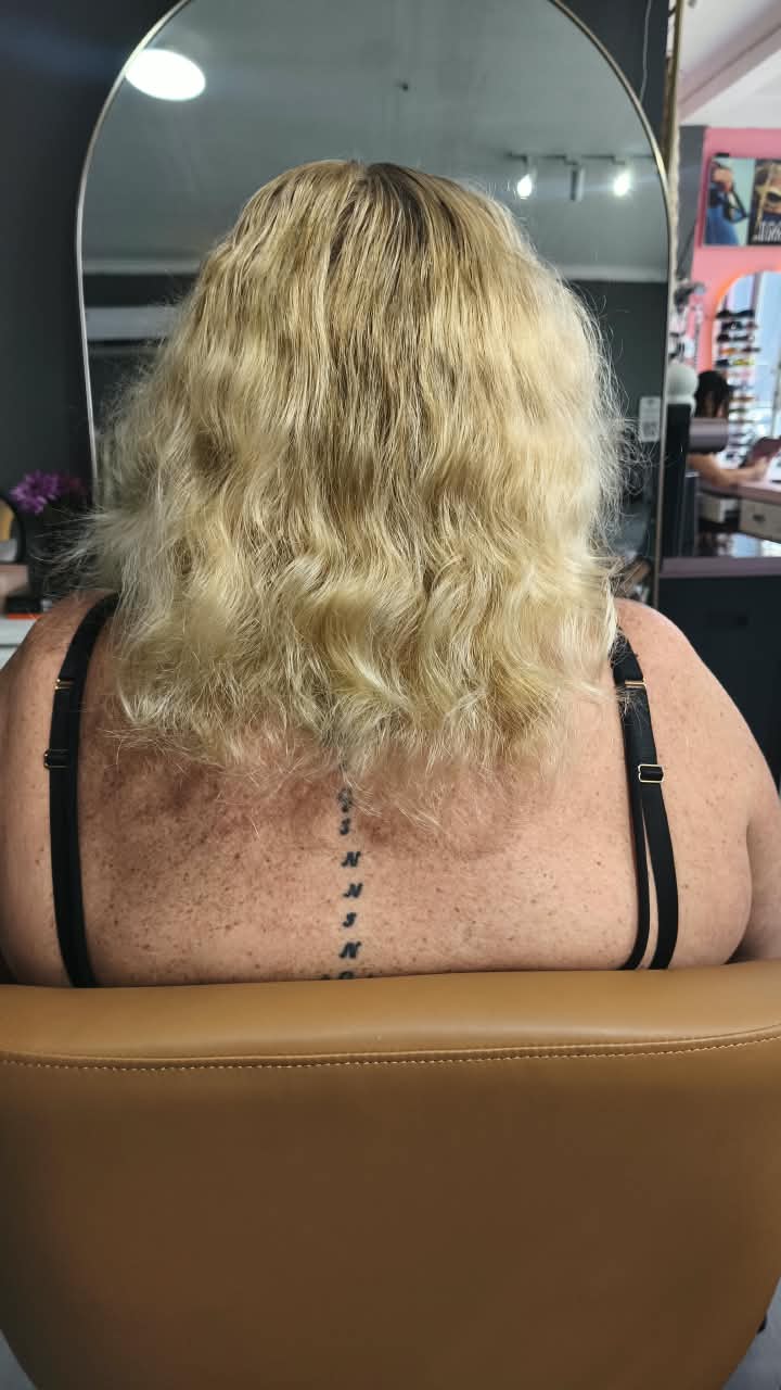 Client before — curly blonde hair to the shoulders