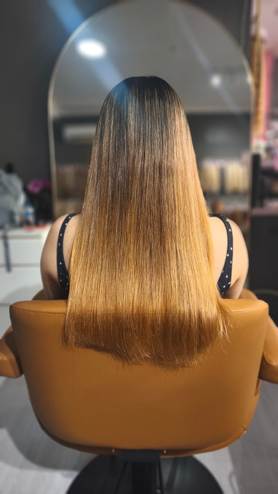 Client before — straight ombre hair, dark roots fading to copper ends
