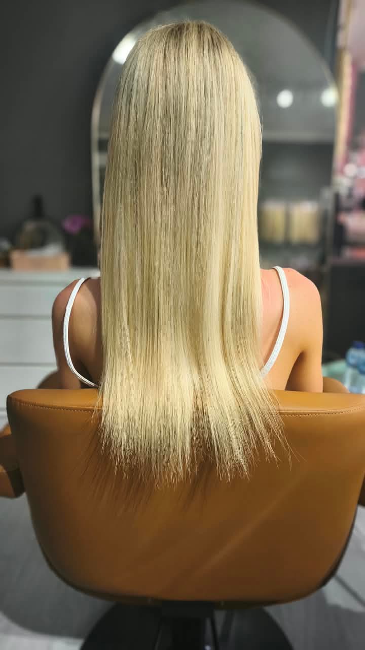 Client before — platinum blonde hair to mid-back, tapering thin through the ends