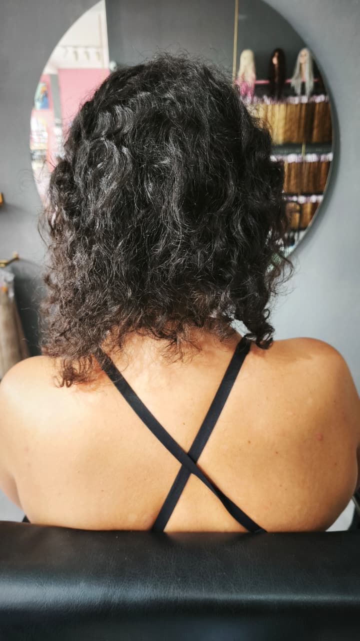 Client before — shoulder-length natural dark curls