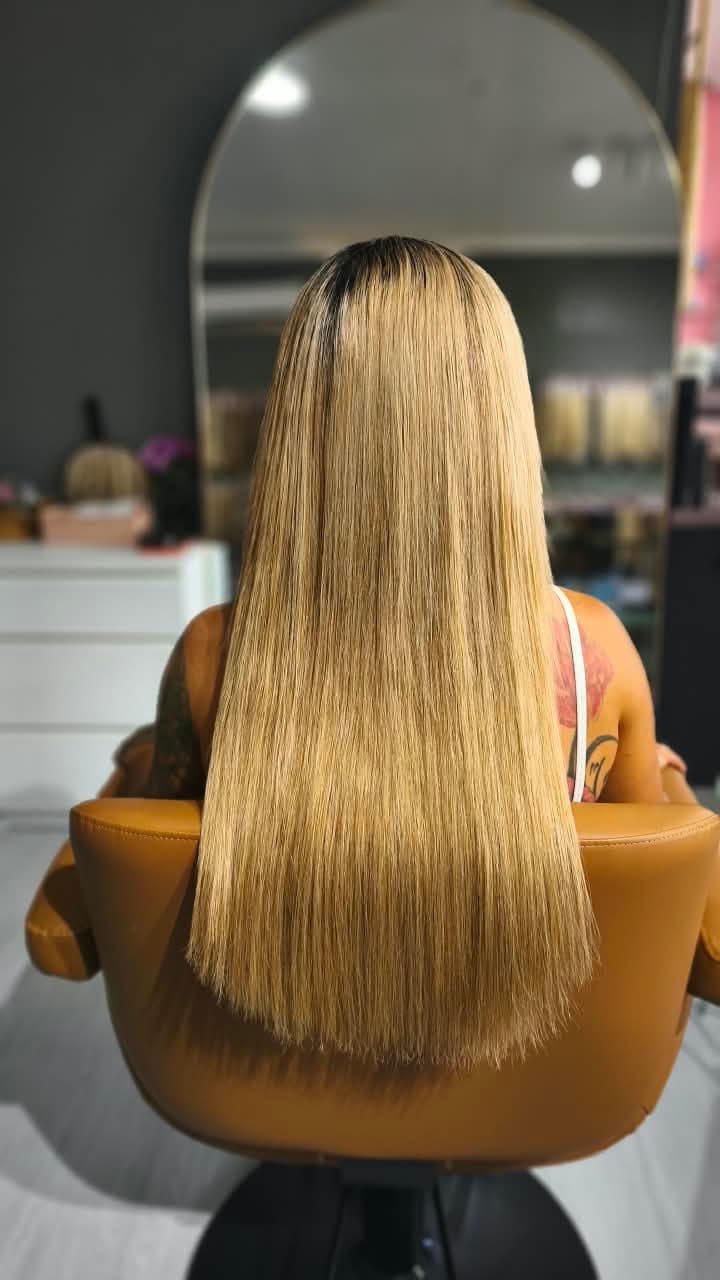 Same client after — long straight blonde past the shoulder blades, Weft double 150 g