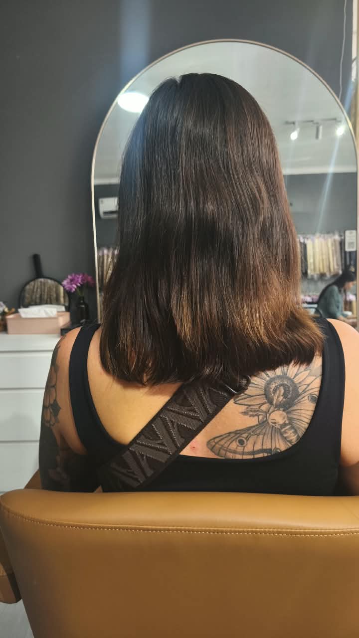 Client before — dark brown hair cut to the shoulders