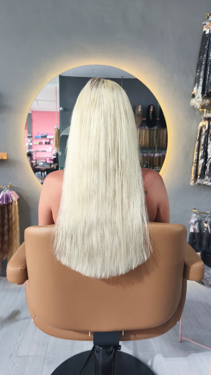 Same client after — long, even platinum blonde to mid-back, Weft double 100 g