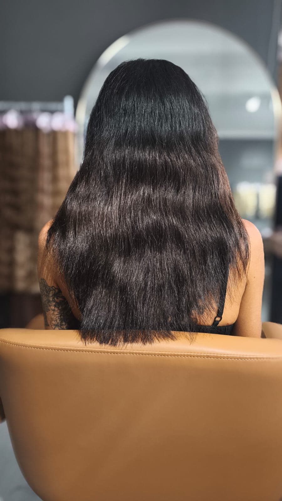 Client before — dark brown waves to the shoulder blades