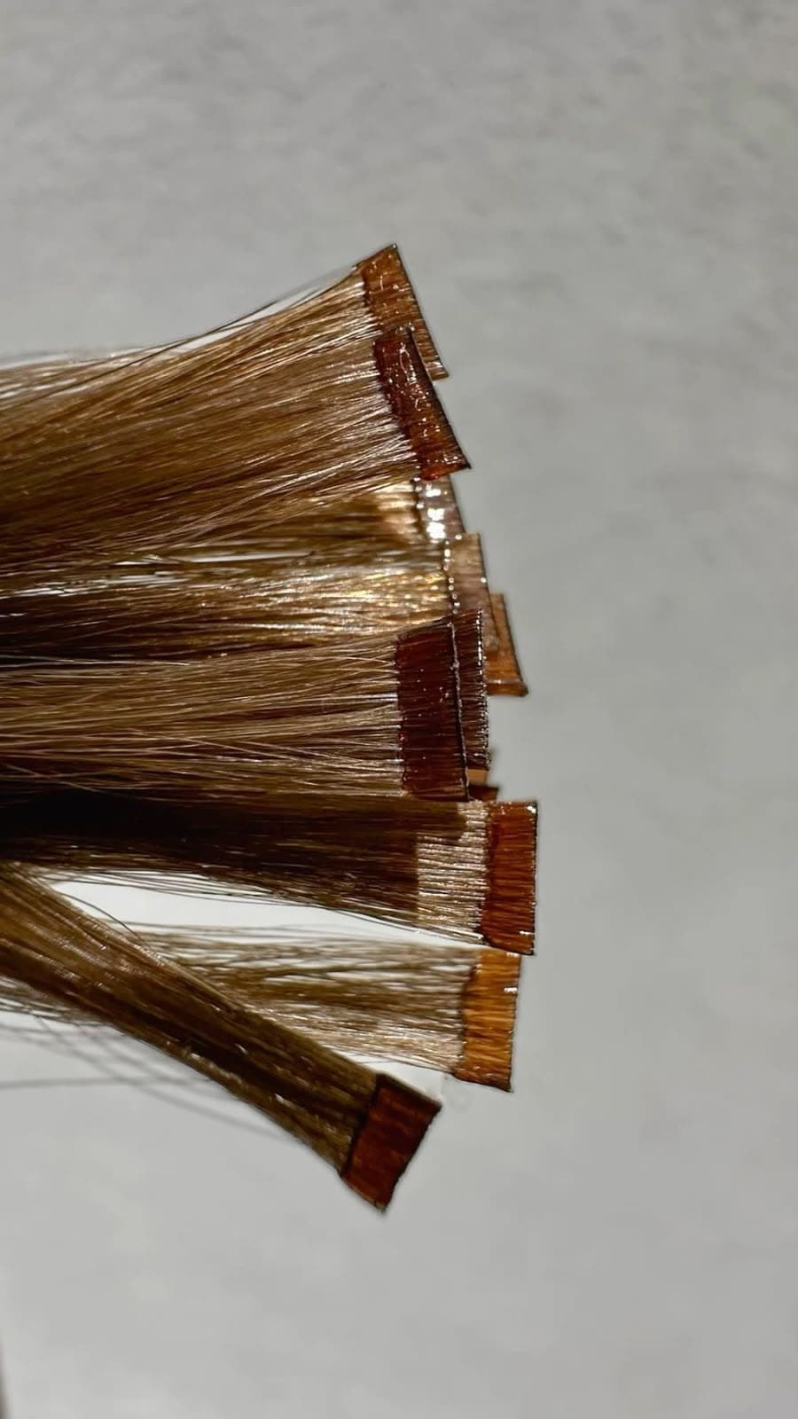 Keratin Bond tips fanned out, flat keratin ends on individual strands